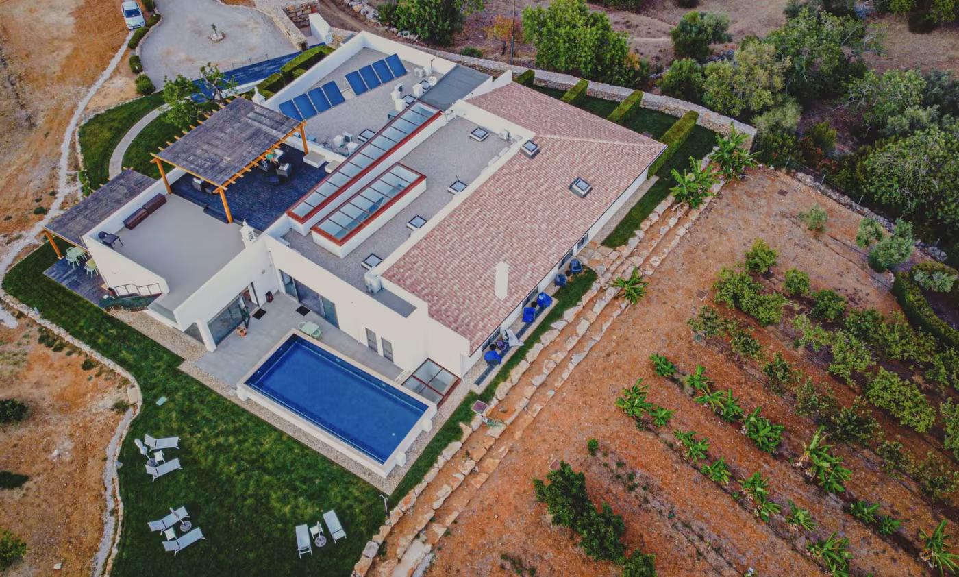 Aerial view of Mercedes Country House with the pool, pergola terrace and orchards around it