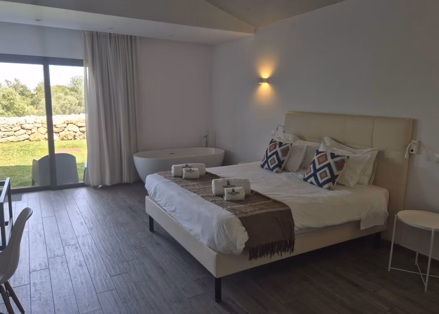 A guest room at Mercedes Country House with a freestanding bath and garden view